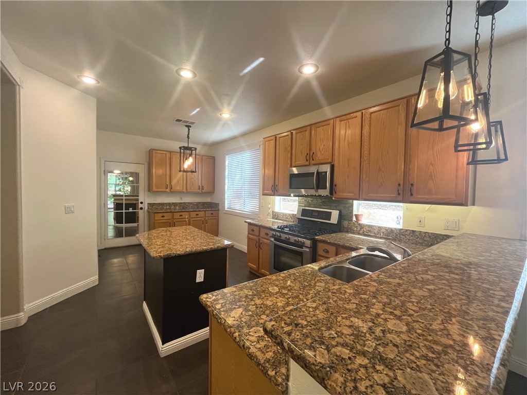 1809 Snow Spring Lane Las Vegas, NV 89134 - Photo 10 of 75 Kitchen w/island & breakfast bar w/granite counters, SS appl, recessed & pendant lights, ceramic tile floors, oak cabinets, dining nook w/add'l cabinets & pantry