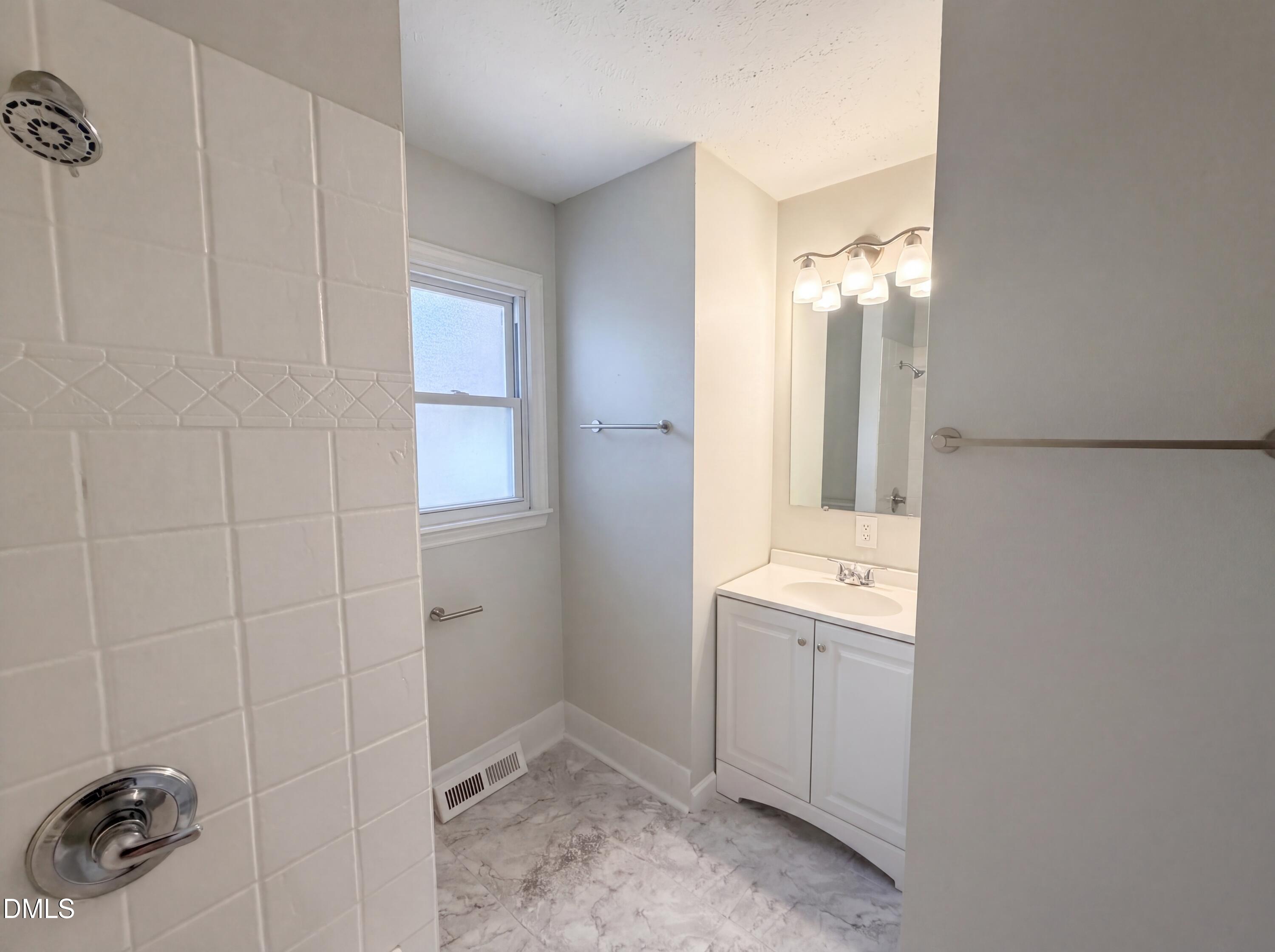 1710 West B Street Butner, NC 27509 - Photo 10 of 14 a bathroom with a sink a toilet and shower