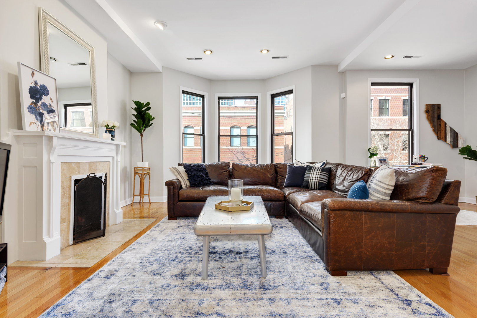 15 East Division Street, Unit 2W Chicago, IL 60611 - Photo 2 of 20 a living room with furniture a large window and a fireplace