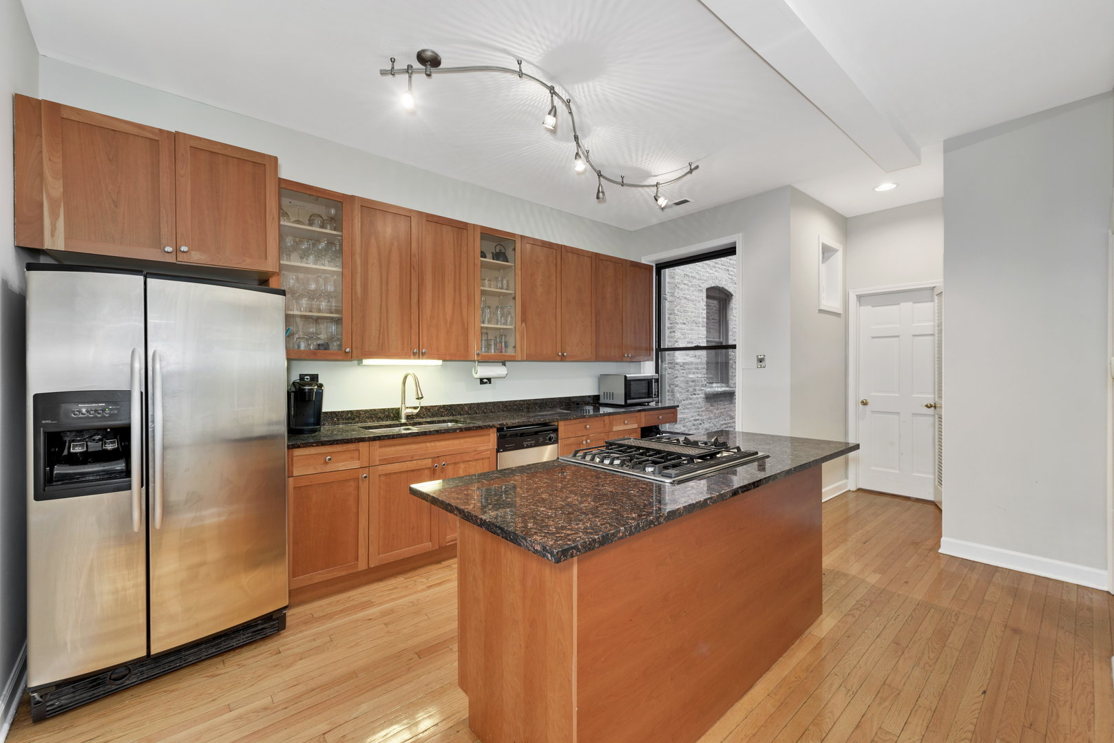 15 East Division Street, Unit 2W Chicago, IL 60611 - Photo 11 of 20 a kitchen with stainless steel appliances granite countertop a sink stove and refrigerator