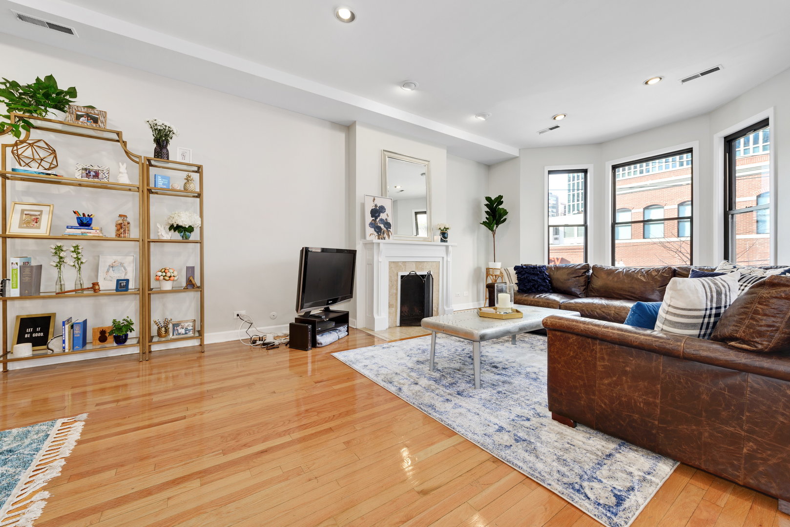15 East Division Street, Unit 2W Chicago, IL 60611 - Photo 3 of 20 a living room with furniture a fireplace and a large window