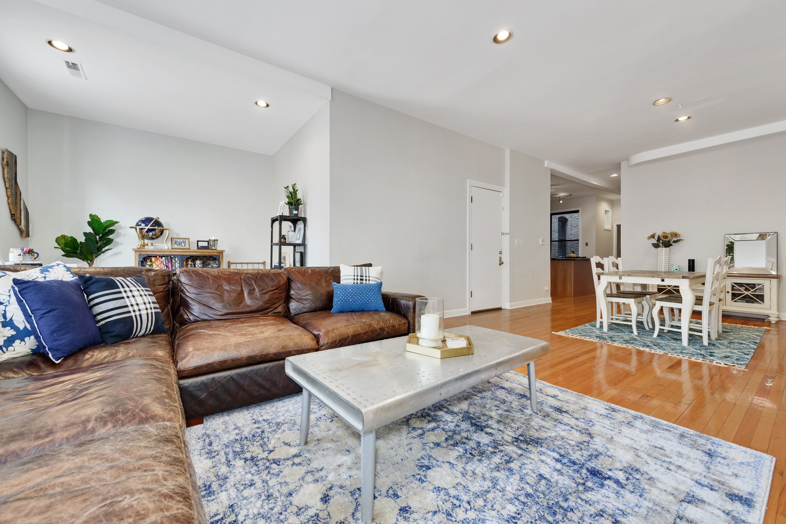 15 East Division Street, Unit 2W Chicago, IL 60611 - Photo 9 of 20 a living room with furniture a rug and a dining table with wooden floor