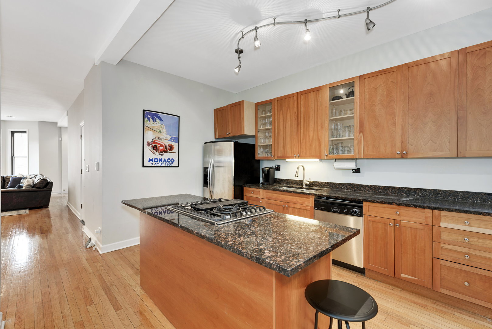 15 East Division Street, Unit 2W Chicago, IL 60611 - Photo 10 of 20 a kitchen with granite countertop a sink cabinets and wooden floor