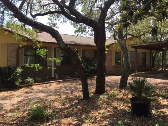 a view of a house with a yard covered in snow