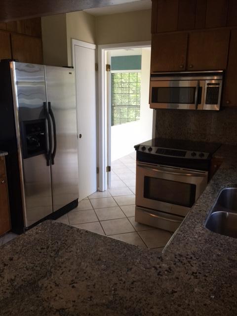 2055 Christensen Drive Navarre, FL 32566 - Photo 14 of 25 a metallic refrigerator freezer sitting in a kitchen