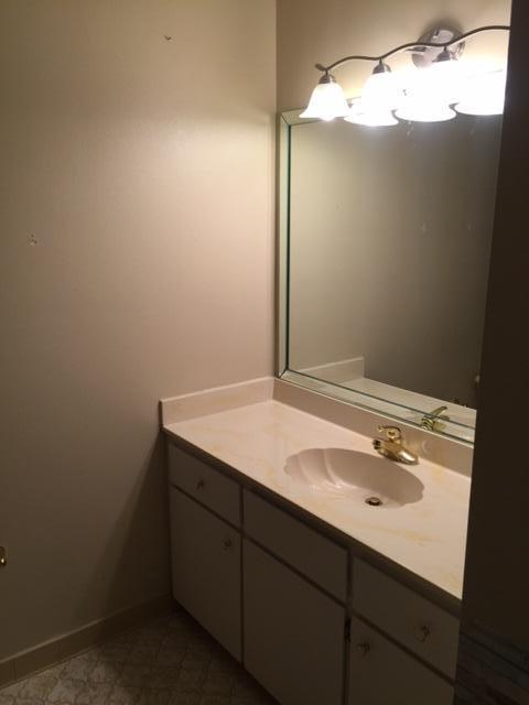 2055 Christensen Drive Navarre, FL 32566 - Photo 16 of 25 a bathroom with a sink vanity and a mirror