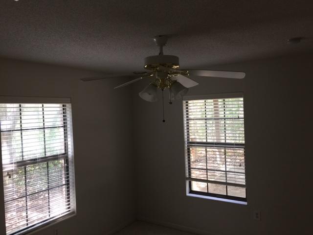 2055 Christensen Drive Navarre, FL 32566 - Photo 19 of 25 an empty room with a empty space and windows