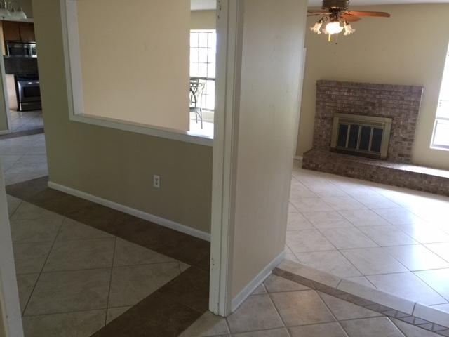 2055 Christensen Drive Navarre, FL 32566 - Photo 25 of 25 an empty room with windows and fireplace
