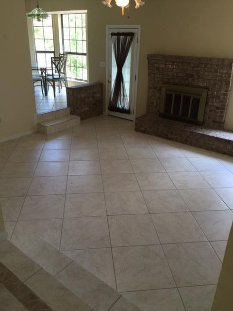 2055 Christensen Drive Navarre, FL 32566 - Photo 3 of 25 a living room with a fireplace and a table