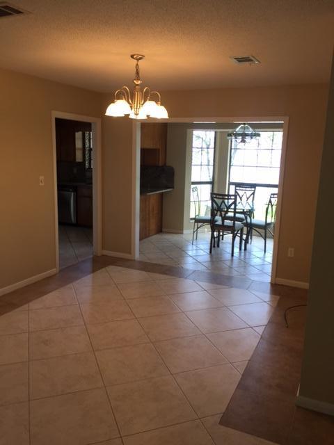 2055 Christensen Drive Navarre, FL 32566 - Photo 7 of 25 a view of a dining room with furniture and chandelier