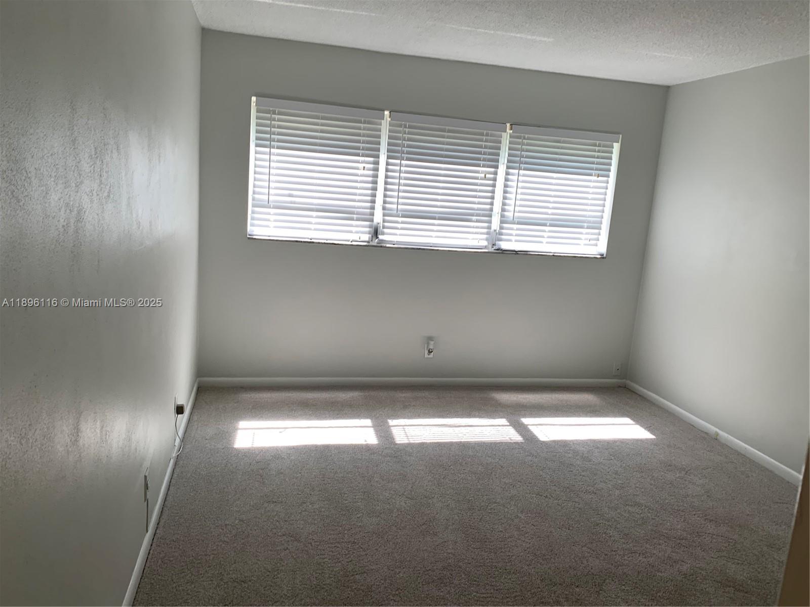 400 Northeast 20th Street, Unit A108 Boca Raton, FL 33431 - Photo 11 of 35 a view of empty room with window