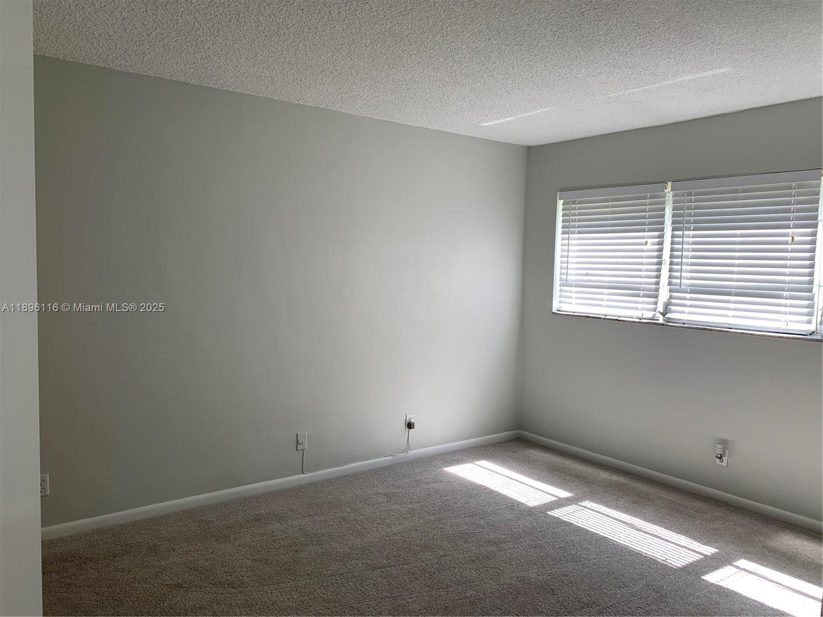 400 Northeast 20th Street, Unit A108 Boca Raton, FL 33431 - Photo 12 of 35 a view of an empty room with a window