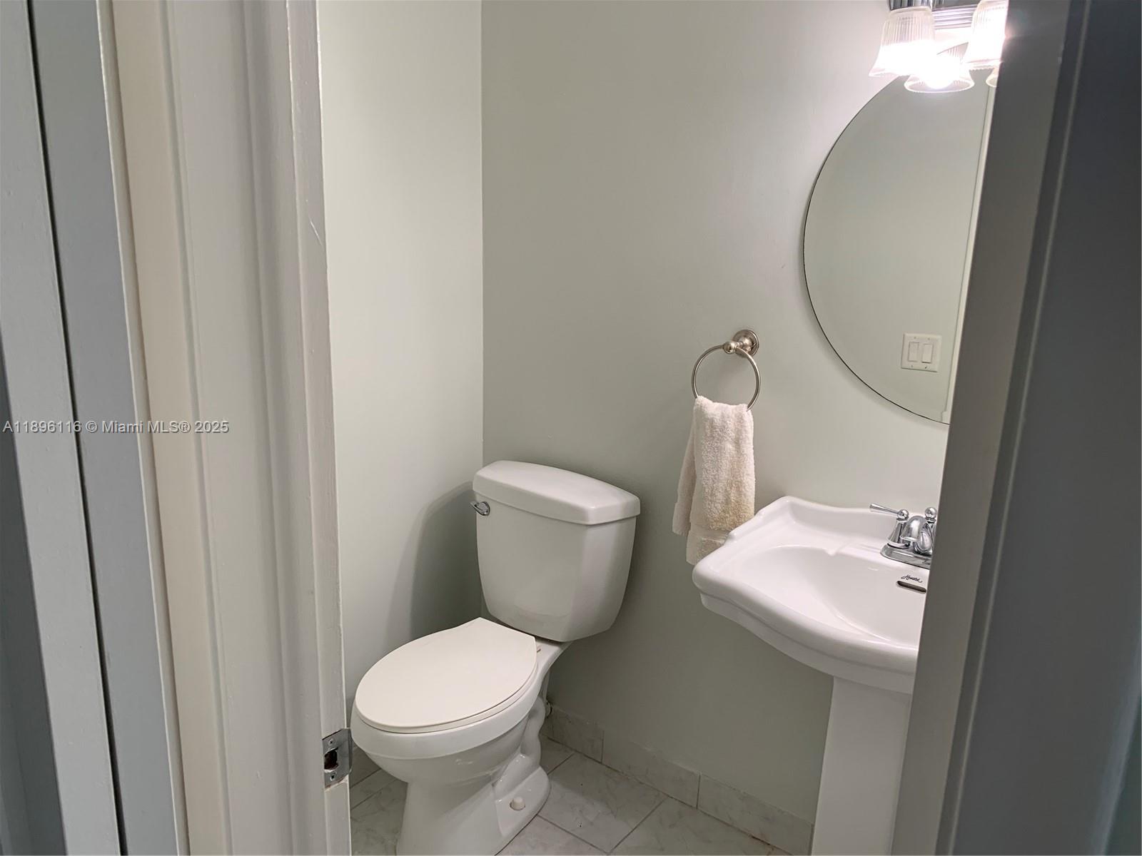 400 Northeast 20th Street, Unit A108 Boca Raton, FL 33431 - Photo 19 of 35 a white toilet sitting next to a white sink