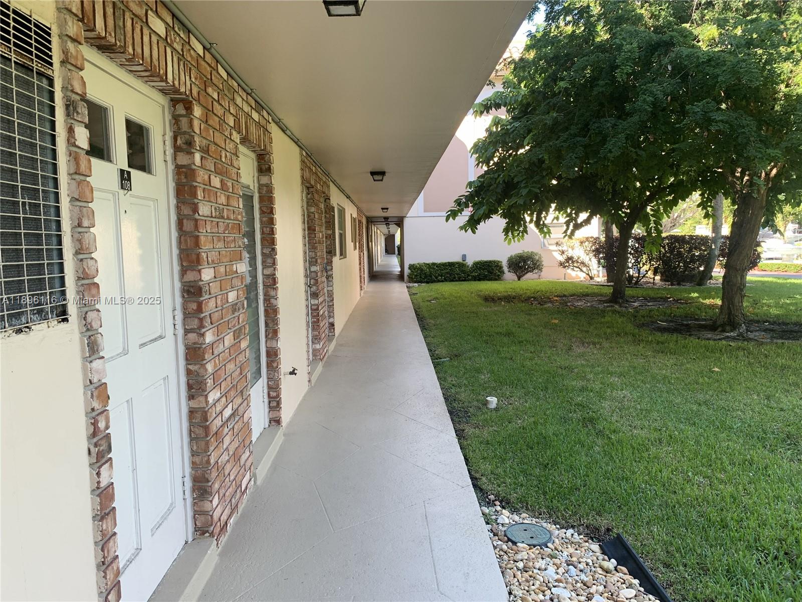 400 Northeast 20th Street, Unit A108 Boca Raton, FL 33431 - Photo 2 of 35 a view of a pathway of a building