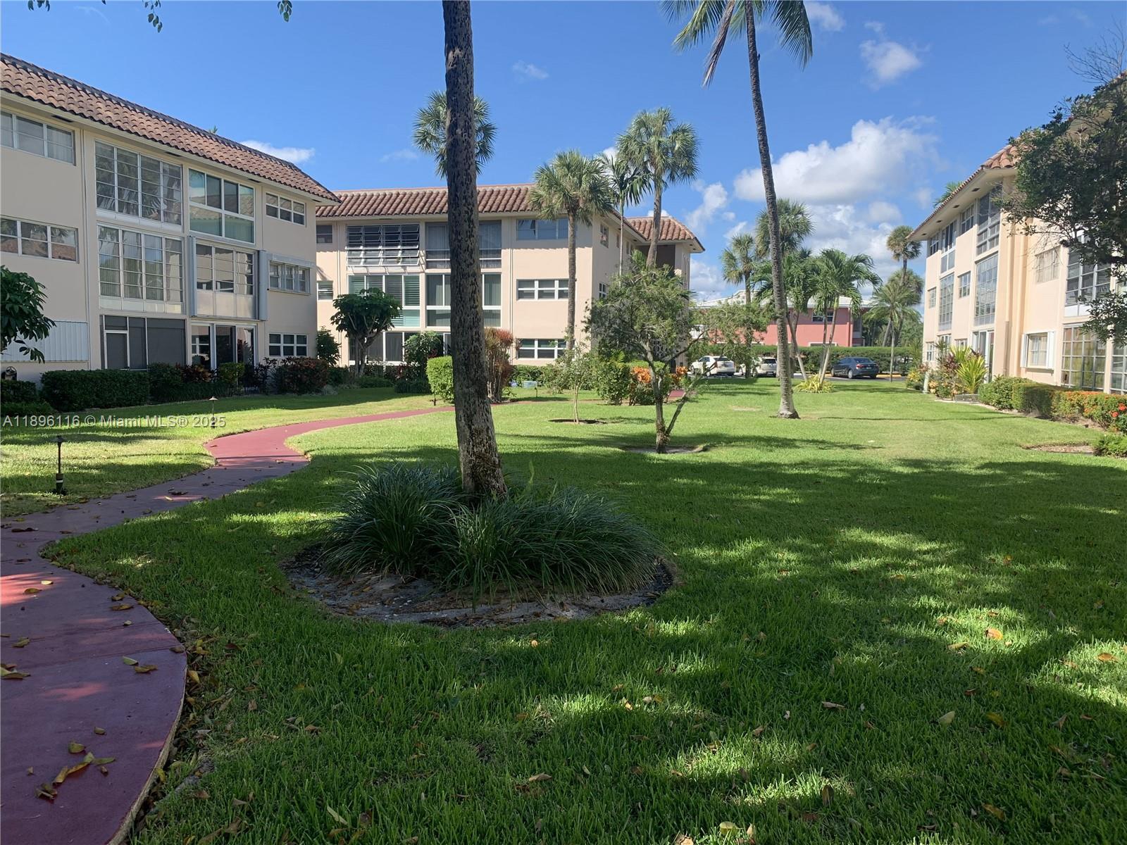 400 Northeast 20th Street, Unit A108 Boca Raton, FL 33431 - Photo 21 of 35 a view of a big building with a big yard and plants