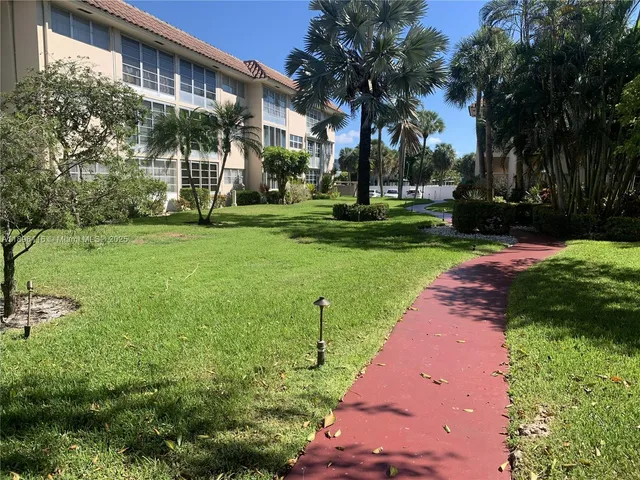 a view of a house with a yard and plants