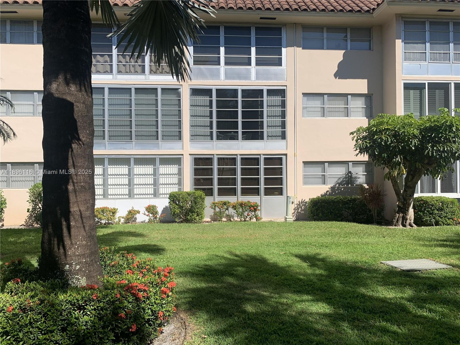 400 Northeast 20th Street, Unit A108 Boca Raton, FL 33431 - Photo 23 of 35 a view of a house with a yard and plants