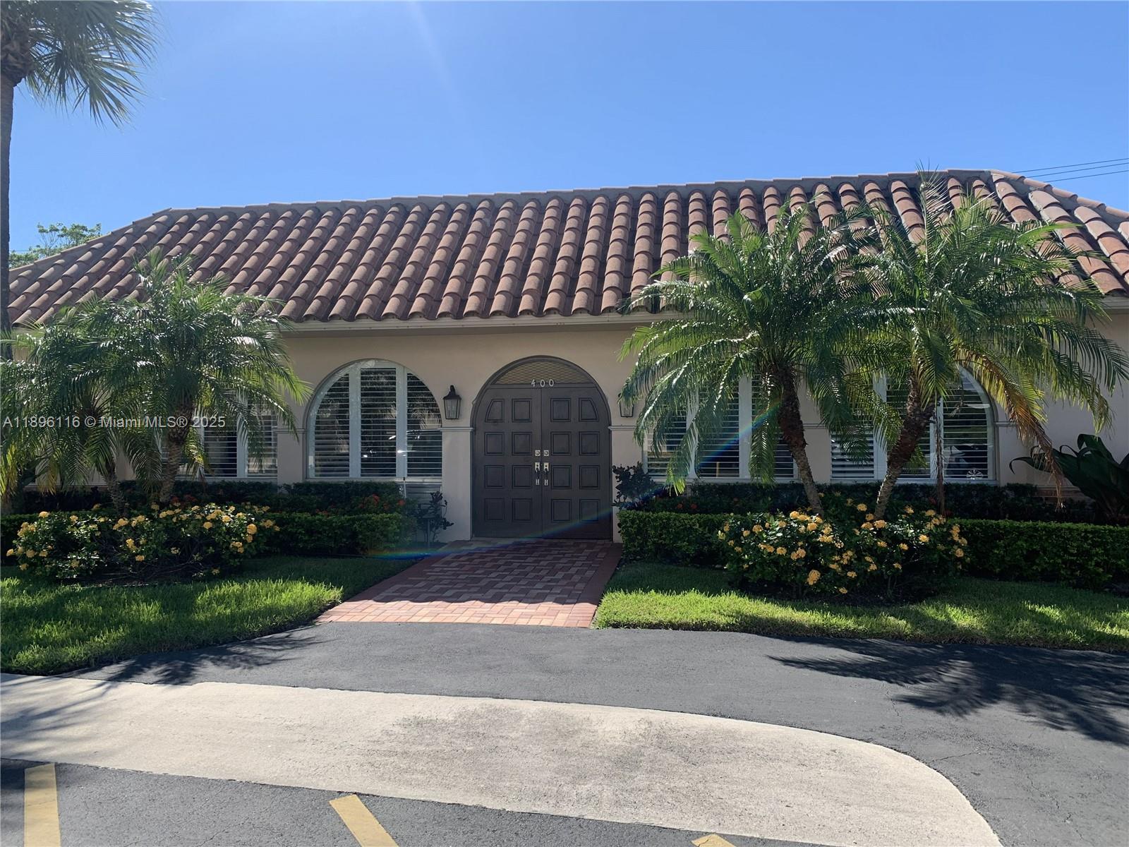 400 Northeast 20th Street, Unit A108 Boca Raton, FL 33431 - Photo 25 of 35 a front view of a house with garden