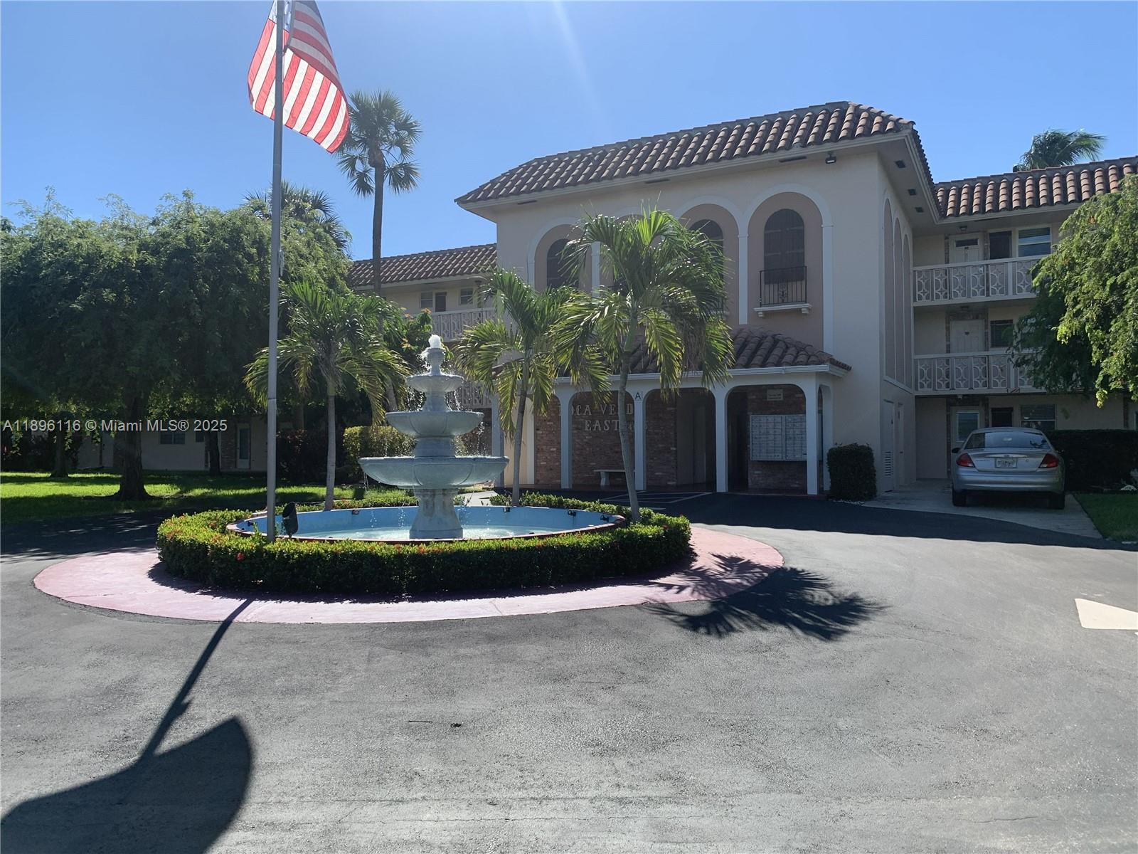 400 Northeast 20th Street, Unit A108 Boca Raton, FL 33431 - Photo 4 of 35 a front view of a house with a yard