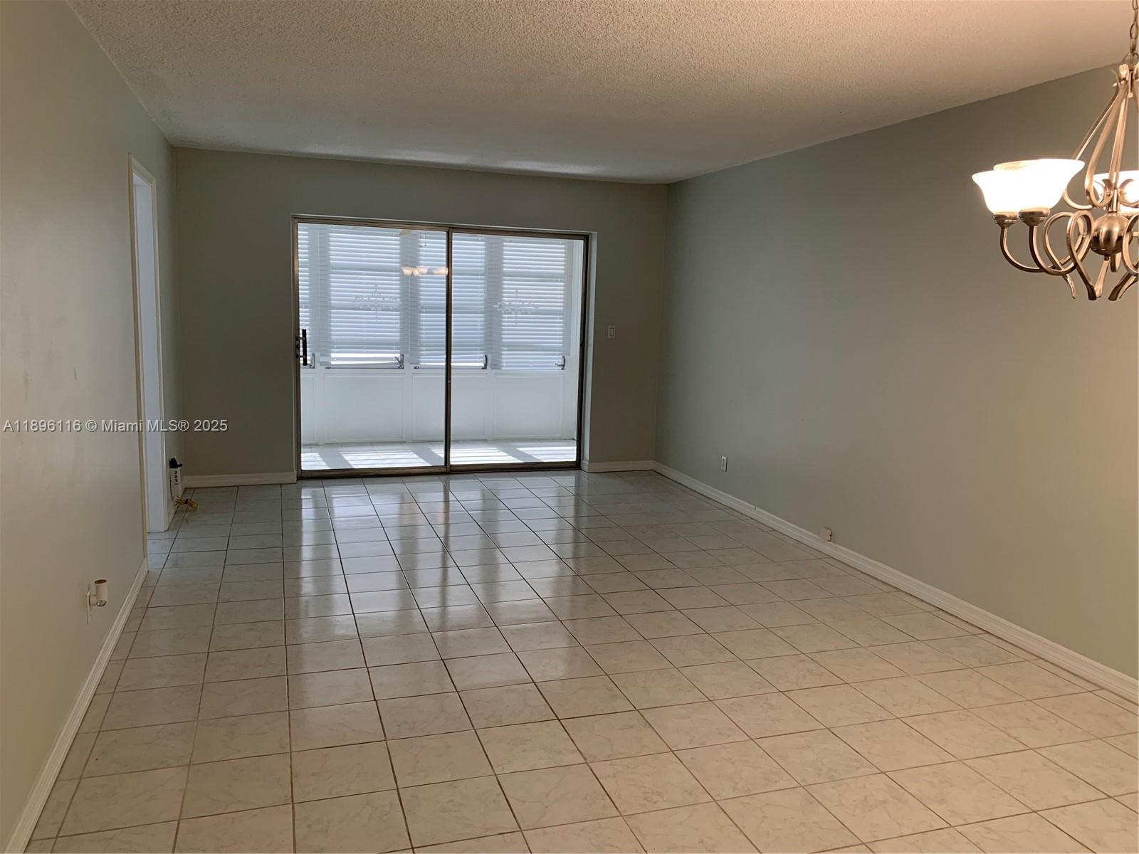 400 Northeast 20th Street, Unit A108 Boca Raton, FL 33431 - Photo 6 of 35 wooden floor in an empty room with a window