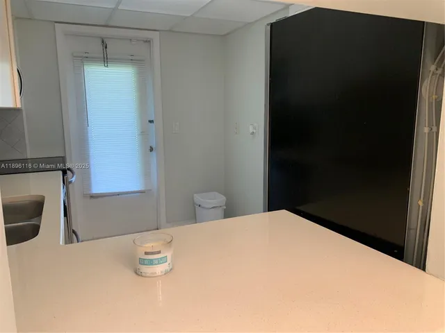 a kitchen with a refrigerator sink and cabinets