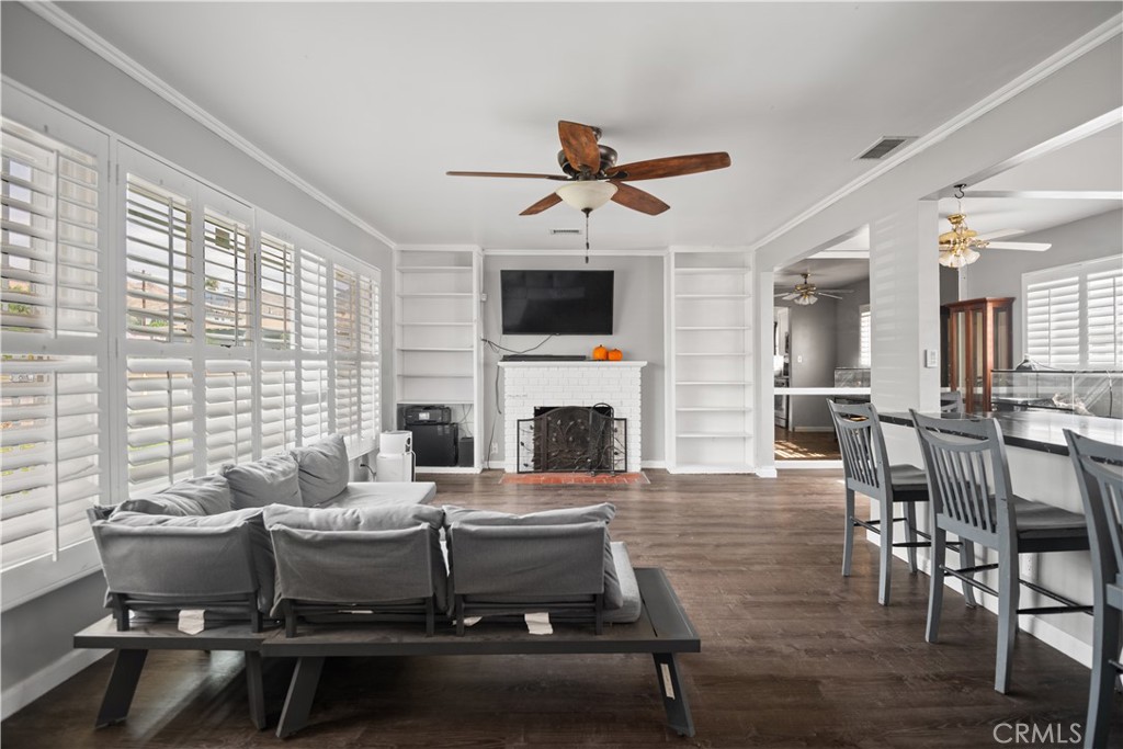 1555 Toluca Drive East San Bernardino, CA 92404 - Photo 3 of 13 a living room with furniture a fireplace and a flat screen tv