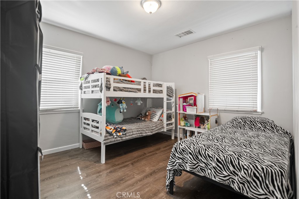 1555 Toluca Drive East San Bernardino, CA 92404 - Photo 8 of 13 a bedroom with a bed and a window