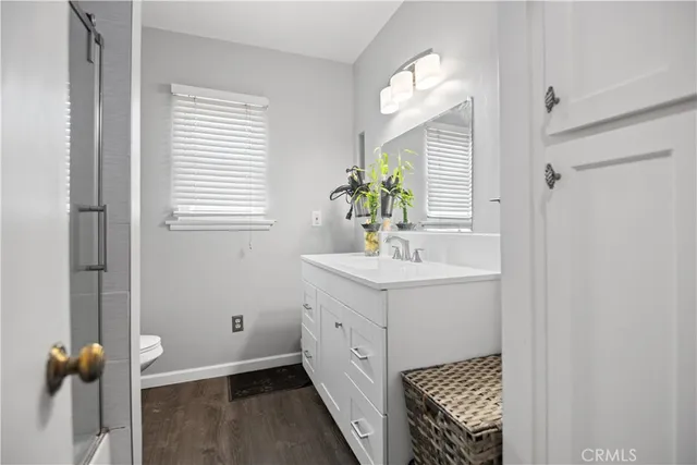 a bathroom with a sink a mirror and a window