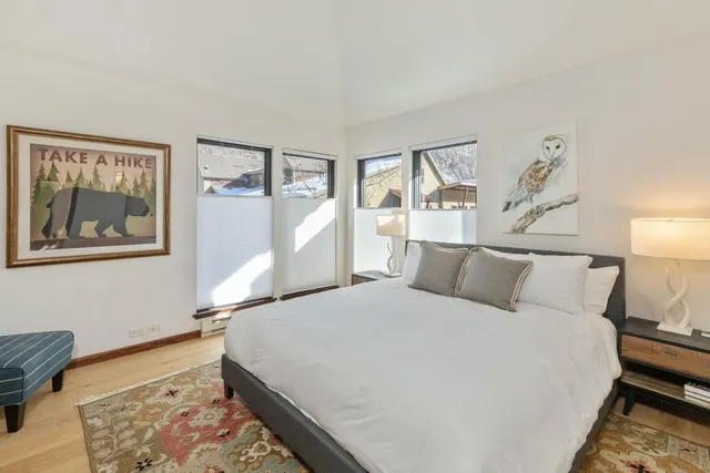 a bed room with a bed and a painting on the wall