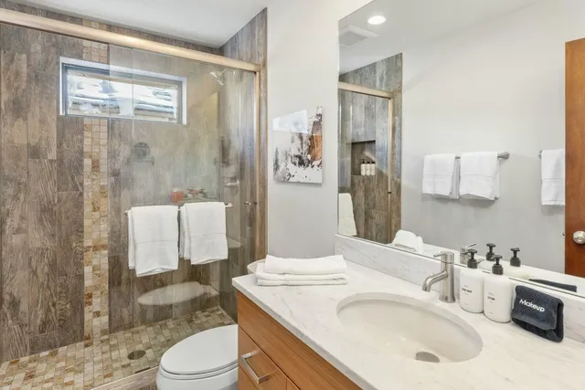 a bathroom with a sink toilet and shower