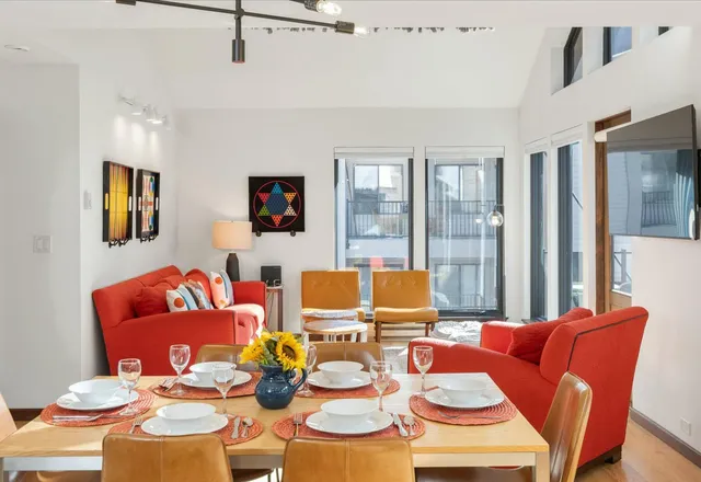 a living room filled with furniture and floor to ceiling windows