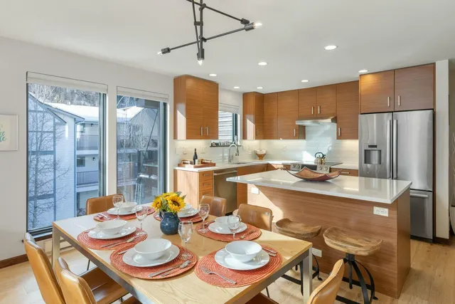 a kitchen with a dining table and chairs