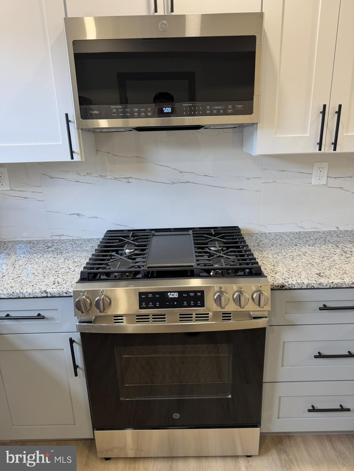 7816 Temple Road Philadelphia, PA 19150 - Photo 6 of 24 a stove top oven sitting inside of a kitchen and granite counter tops