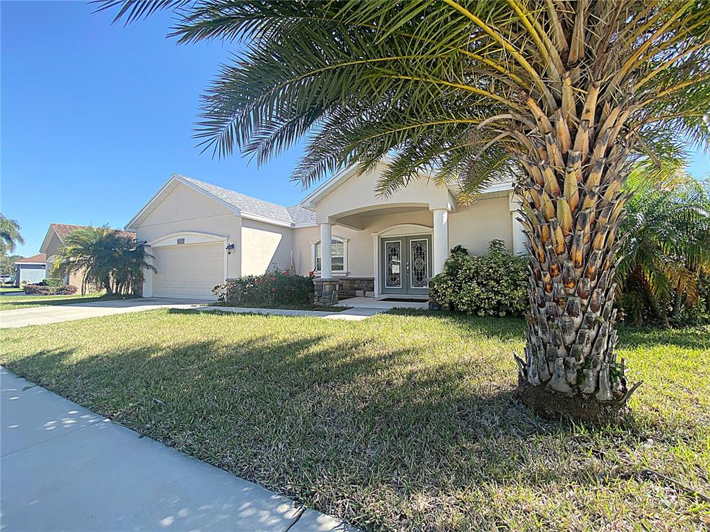 a front view of house with yard and outdoor seating