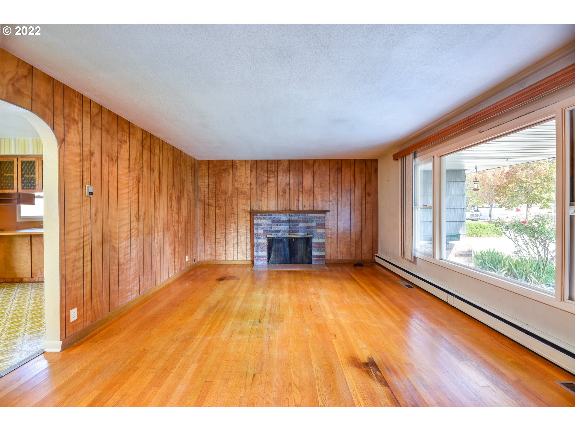 2308 Don Street Springfield, OR 97477 - Photo 5 of 30 a view of an empty room with a fireplace and a window