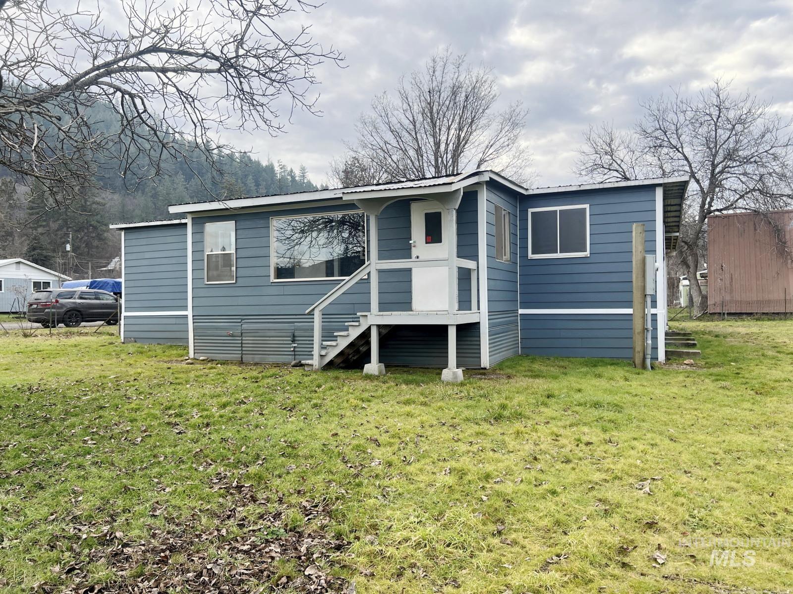 614 Pine Avenue Kooskia, ID 83539 - Photo 26 of 27 Rear view of property with a yard and a metal roof