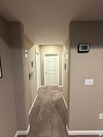 118 Tram Rock Rd. Lake Point, UT 84074 - Photo 23 of 34 Interior hallway featuring neutral wall paint, white trim, and textured carpeting