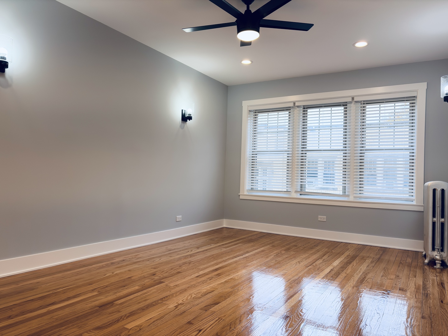 5060 North Wolcott Avenue, Unit 3E Chicago, IL 60640 - Photo 5 of 8 an empty room with wooden floor and windows