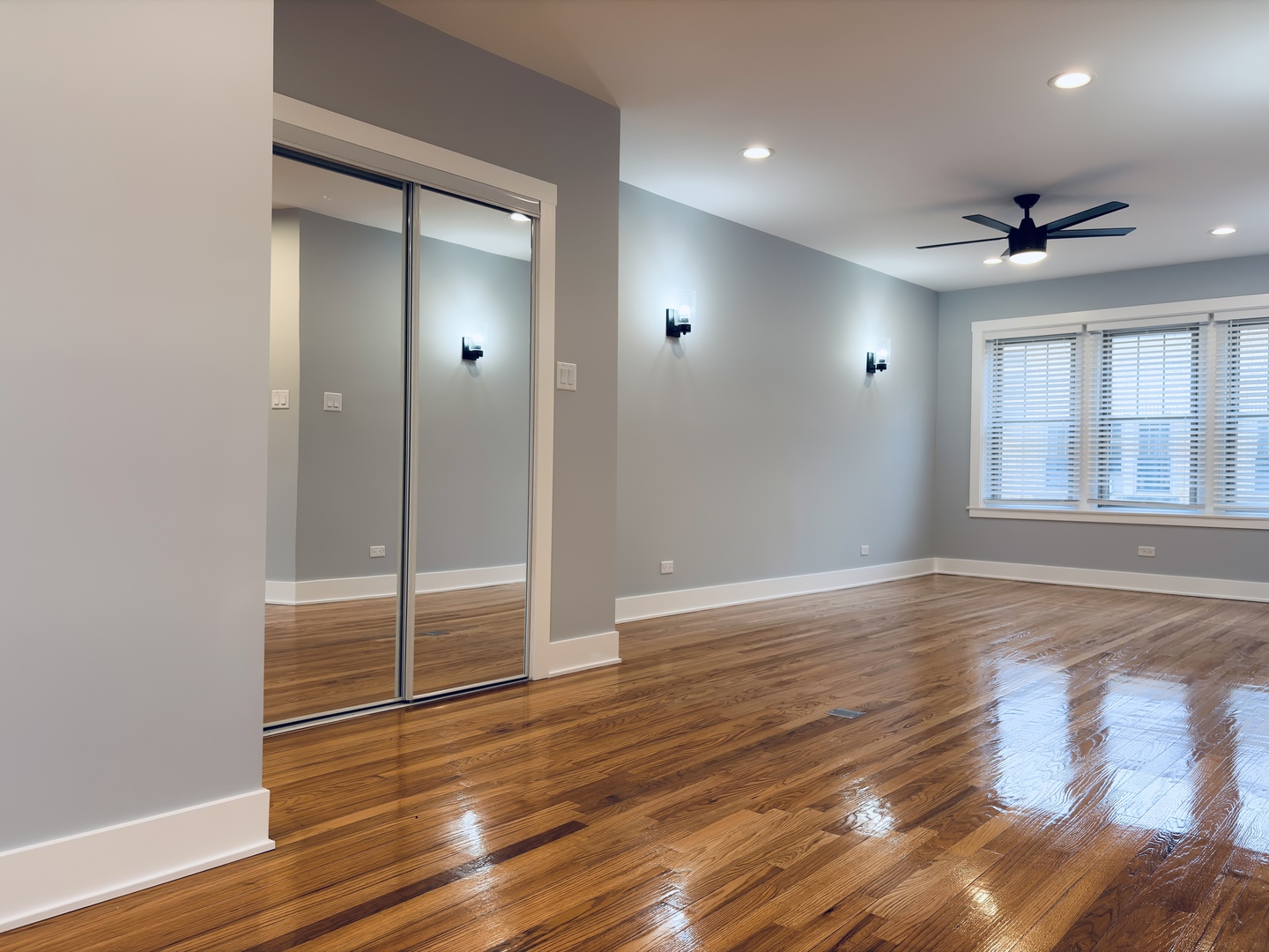 5060 North Wolcott Avenue, Unit 3E Chicago, IL 60640 - Photo 7 of 8 a view of empty room with wooden floor and fan