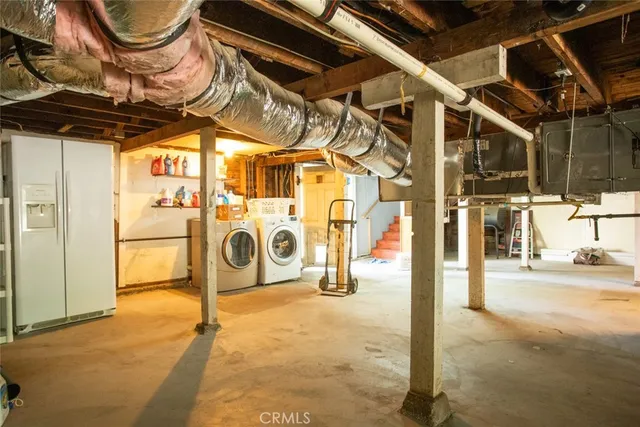 a view of a house with a small yard plants and large tree