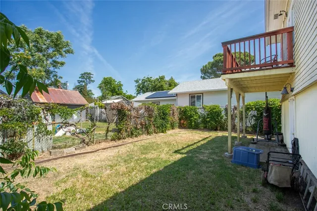 a bedroom with a bed and a flat tv screen on dresser