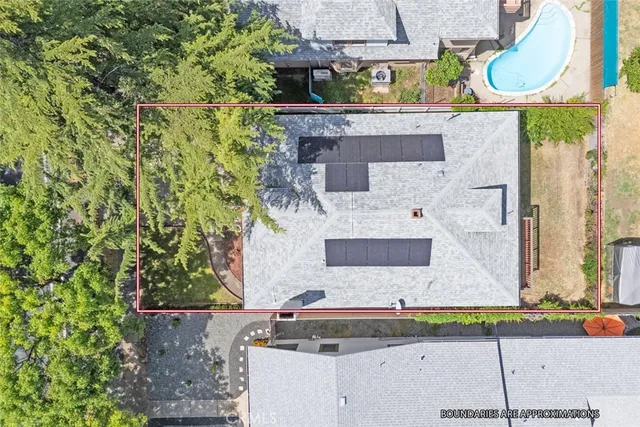 an aerial view of residential houses with outdoor space