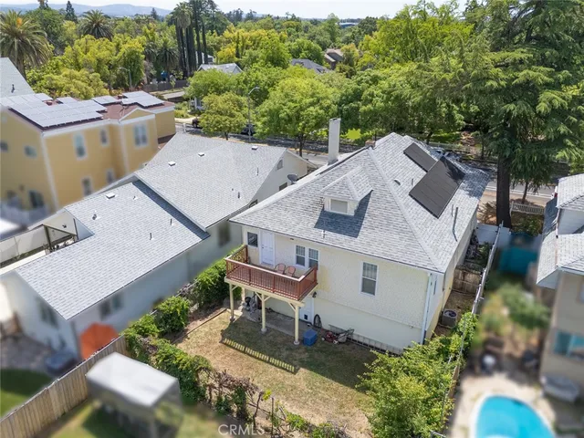 an aerial view of a house with a yard