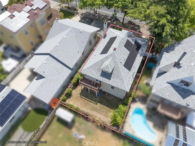 an aerial view of a house with a yard