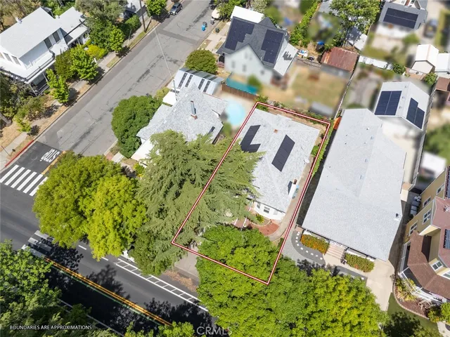 an aerial view of a house with a yard and garden