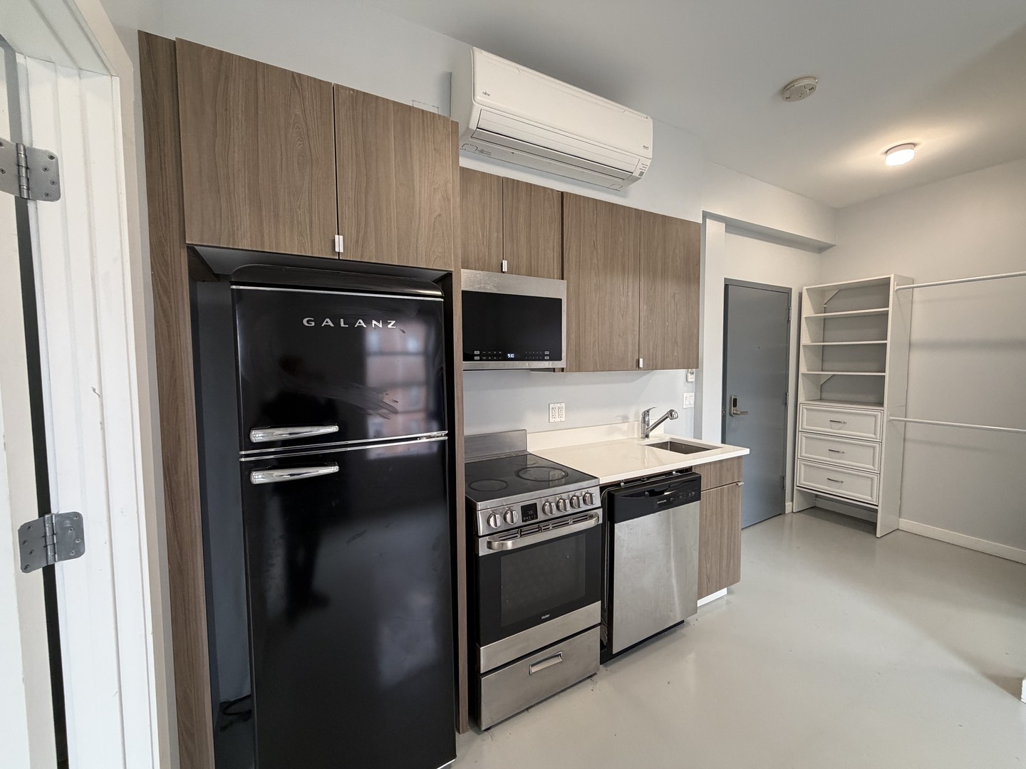 4700 North Racine Avenue, Unit 316 Chicago, IL 60640 - Photo 3 of 6 a kitchen with stainless steel appliances a stove and a refrigerator