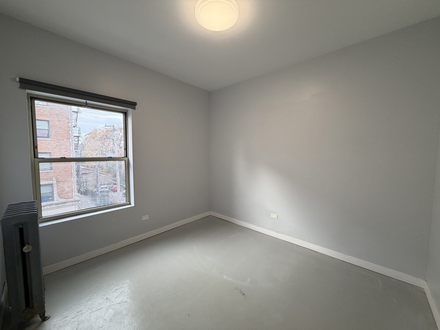 4700 North Racine Avenue, Unit 316 Chicago, IL 60640 - Photo 5 of 6 an empty room with a window