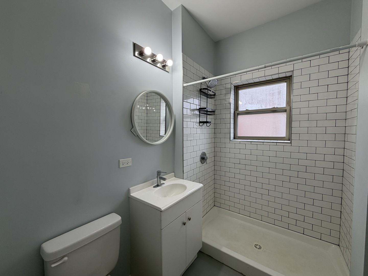 4700 North Racine Avenue, Unit 316 Chicago, IL 60640 - Photo 6 of 6 a bathroom with a toilet a sink a mirror and bathtub