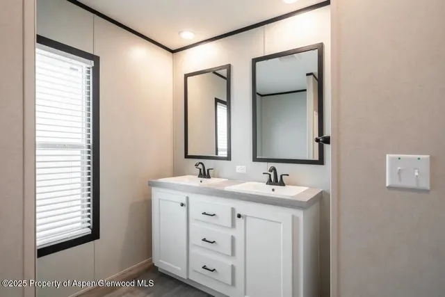 a view of a bathroom with a sink and mirror