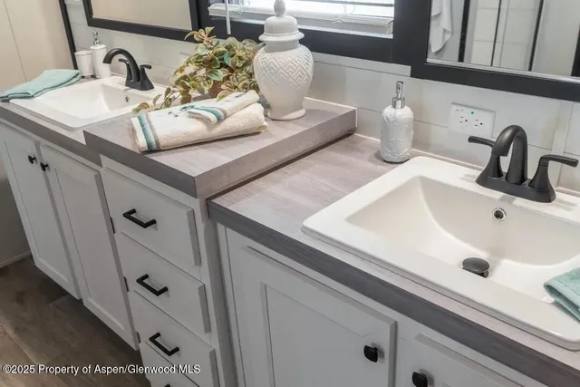 a bathroom with a sink vanity and mirror